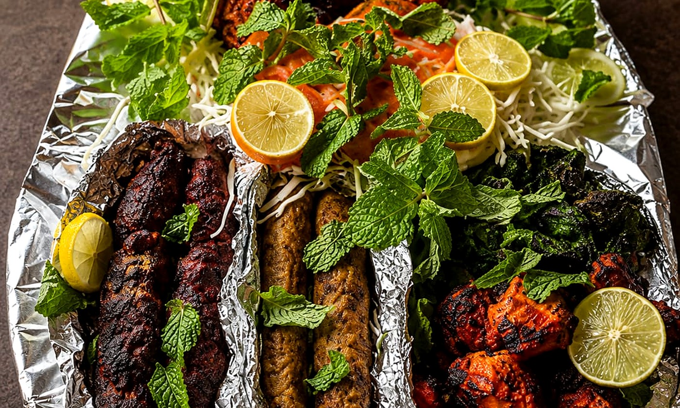 Assorted seekh and tikka kebabs on a platter